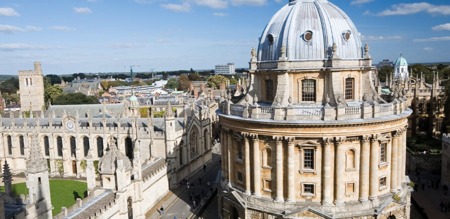 A view of Oxford Radcliffe building with bright blue skies and other buildings surroning it