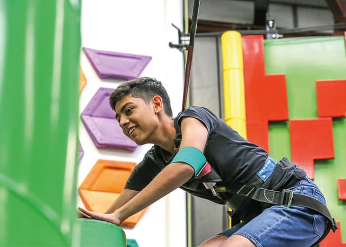 Cambridge College student at climbing wall UK