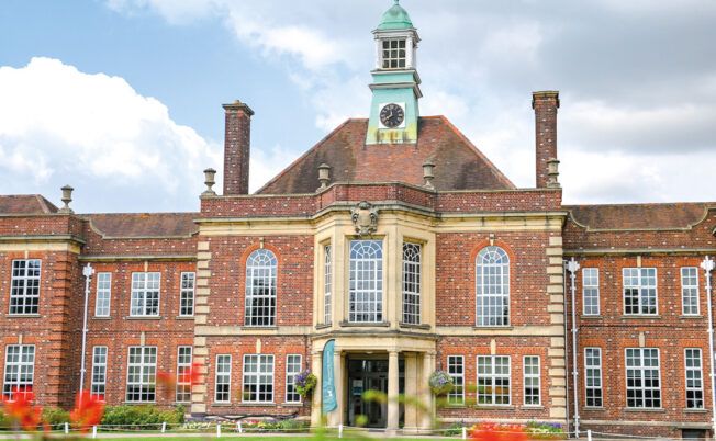 Headington Oxford building with flowers in front and bright green grass, this is where 澳洲五号码结果 Summer Boarding Courses Headington is held