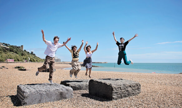 Students jumping at the beech at Earlscliffe Summer School
